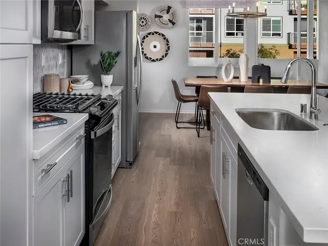 a kitchen with stainless steel appliances granite countertop a stove and a sink