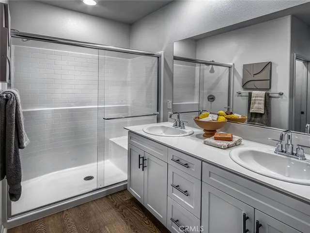 a bathroom with a shower sink vanity granite and mirror