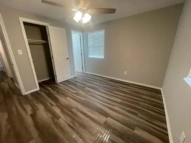 a view of a livingroom with wooden floor and staircase