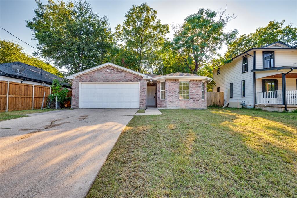 View of front of house featuring concrete driveway, brick siding, and an attached garage