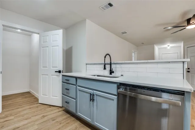 a kitchen with sink a stove and microwave
