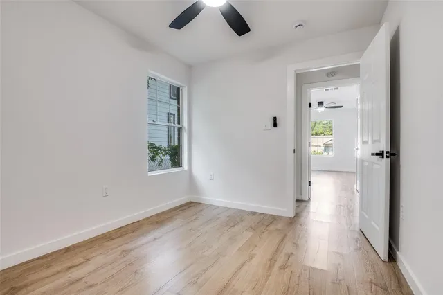 a view of an empty room with wooden floor