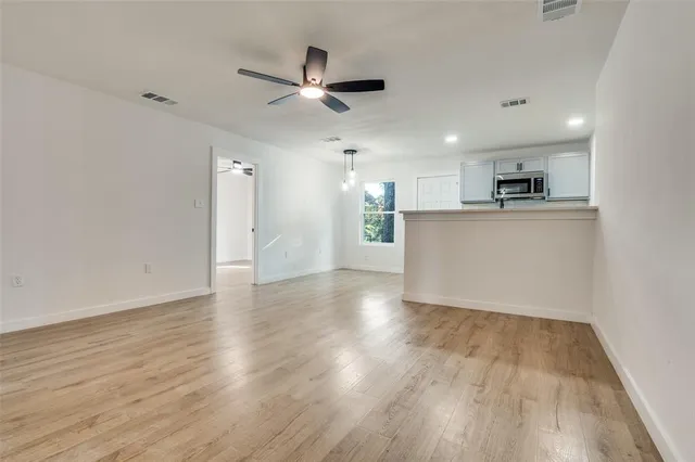 a view of a kitchen with a sink and a refrigerator