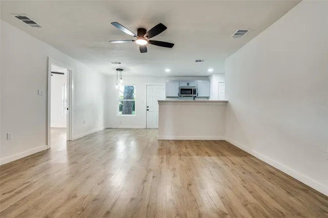 a view of a kitchen with a sink and wooden floor