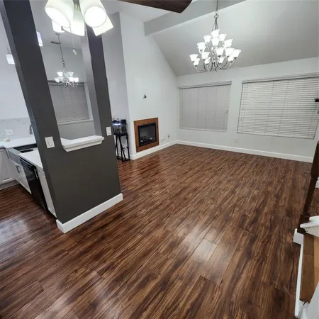 a view of a livingroom with furniture wooden floor and chandelier