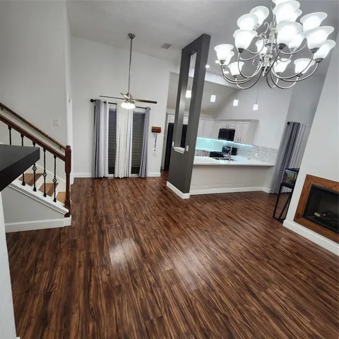 a view of a room with wooden floor and staircase