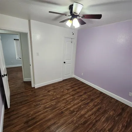 a view of a room with window and a ceiling fan