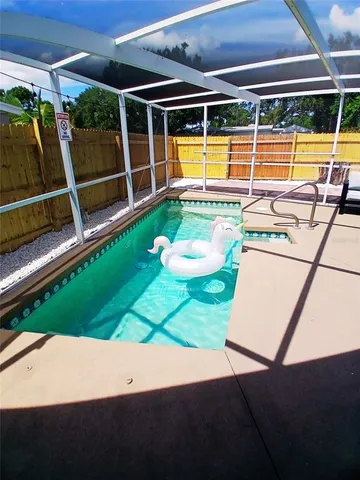 a view of a swimming pool with an outdoor seating and yard