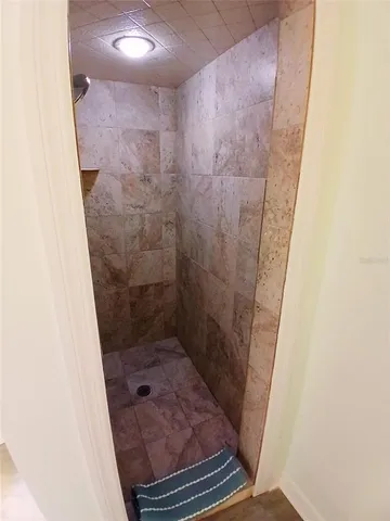 a bathroom with a glass door shower