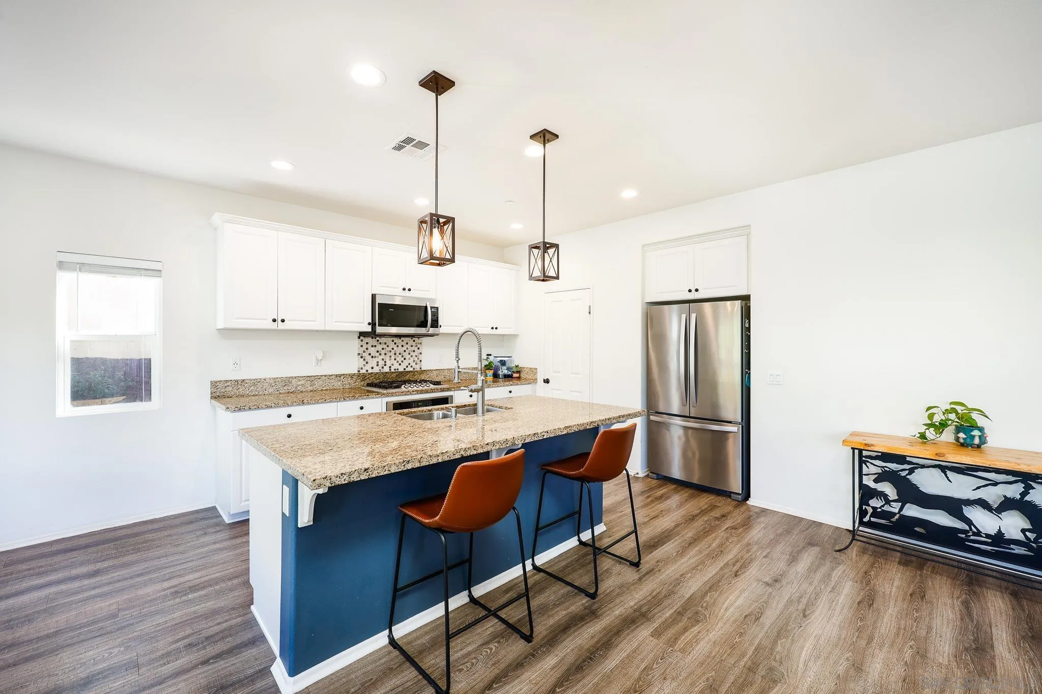 310 Falabella Lane Fallbrook, CA 92028 - Photo 13 of 48 a kitchen with stainless steel appliances granite countertop a sink a stove a refrigerator and island with wooden floor