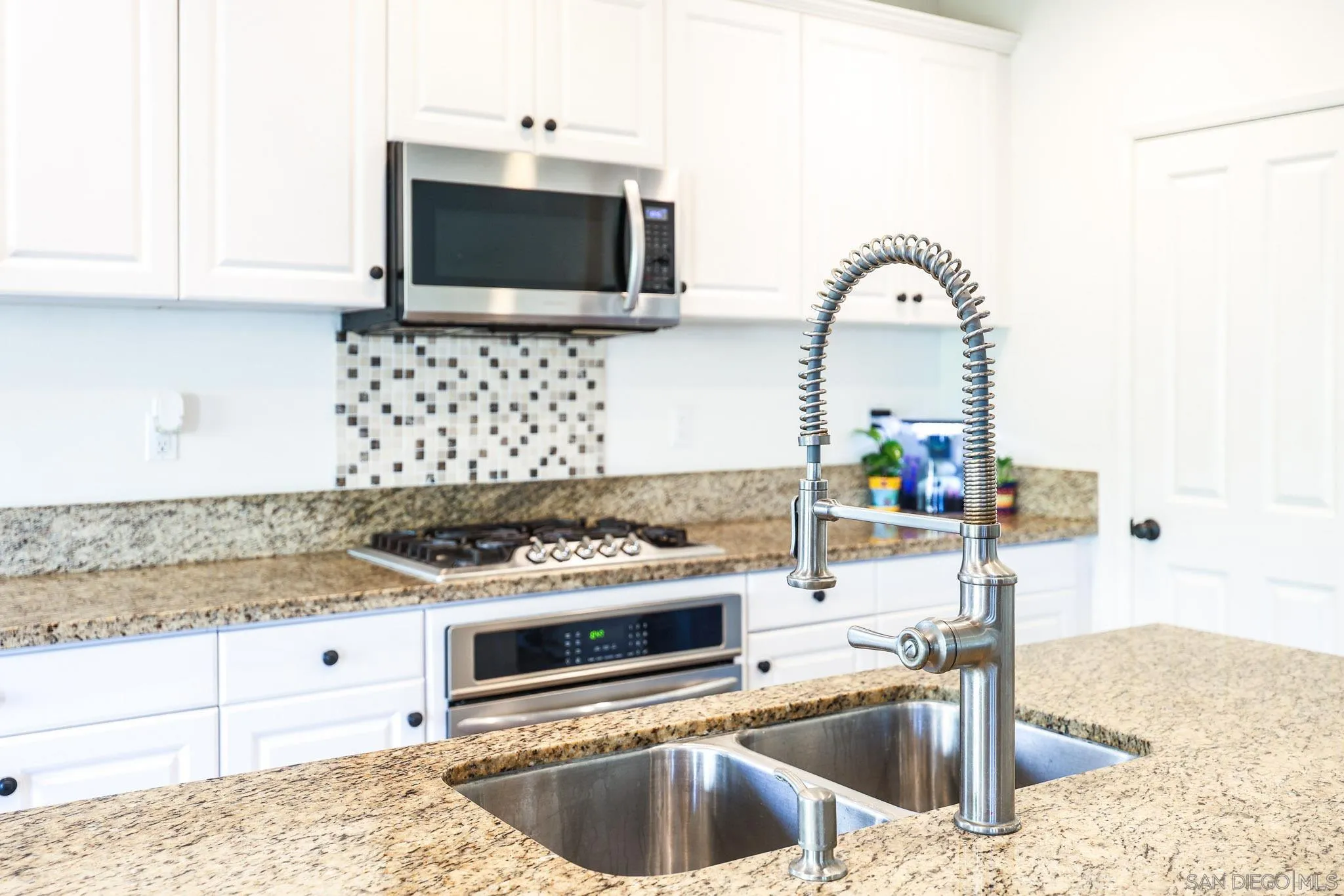 310 Falabella Lane Fallbrook, CA 92028 - Photo 14 of 48 a kitchen with stainless steel appliances granite countertop a sink and a stove