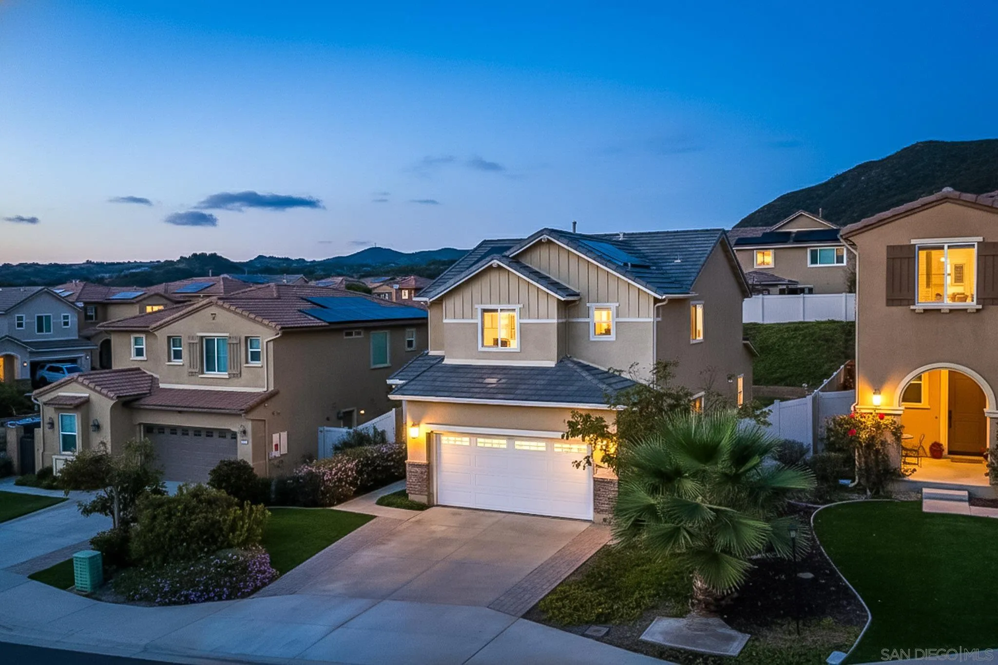 310 Falabella Lane Fallbrook, CA 92028 - Photo 2 of 48 a front view of a house with a yard and garage