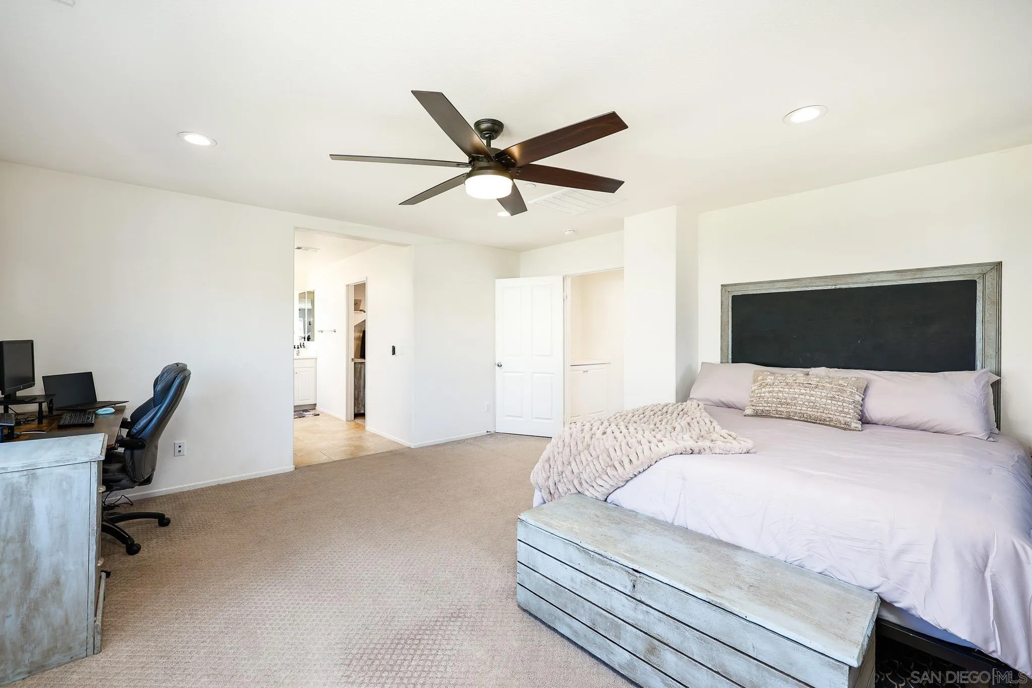 310 Falabella Lane Fallbrook, CA 92028 - Photo 21 of 48 a bedroom with a bed a desk and chair