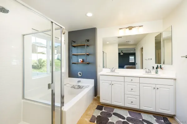 a bathroom with a sink a large mirror and a bathtub