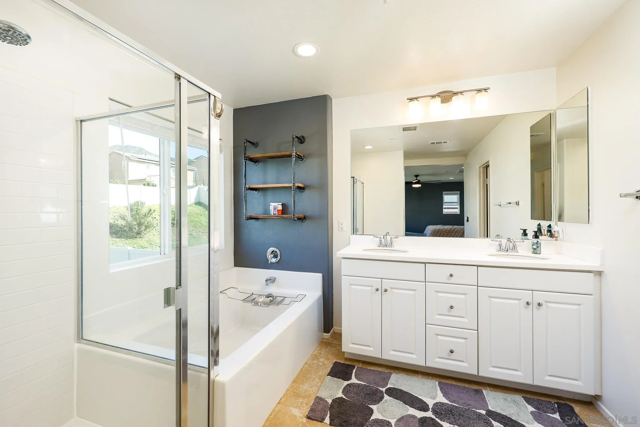 310 Falabella Lane Fallbrook, CA 92028 - Photo 23 of 48 a bathroom with a sink a large mirror and a bathtub