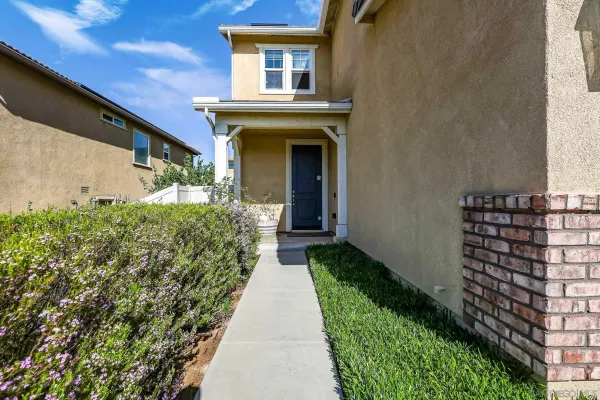 a view of a house with a small yard
