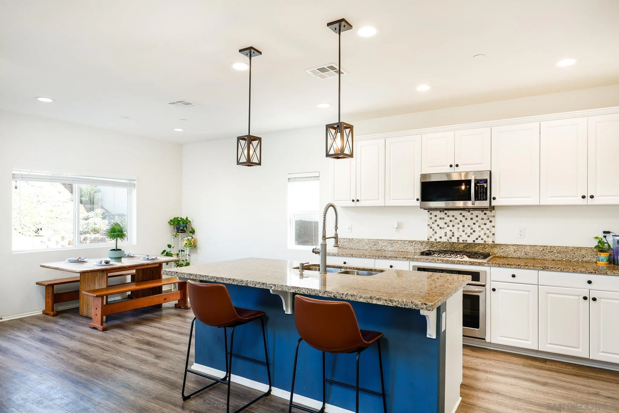 310 Falabella Lane Fallbrook, CA 92028 - Photo 10 of 48 a kitchen with stainless steel appliances kitchen island granite countertop a sink a stove and a center island