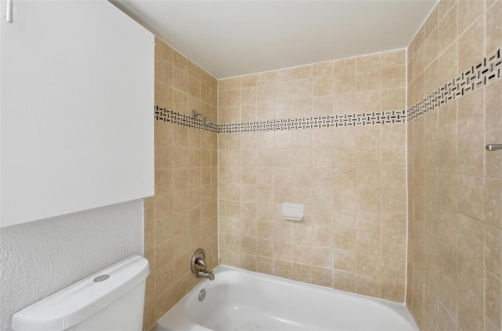 2702 Douglas Avenue, Unit 121 Dallas, TX 75219 - Photo 24 of 34 a bathroom with a shower and a bathtub