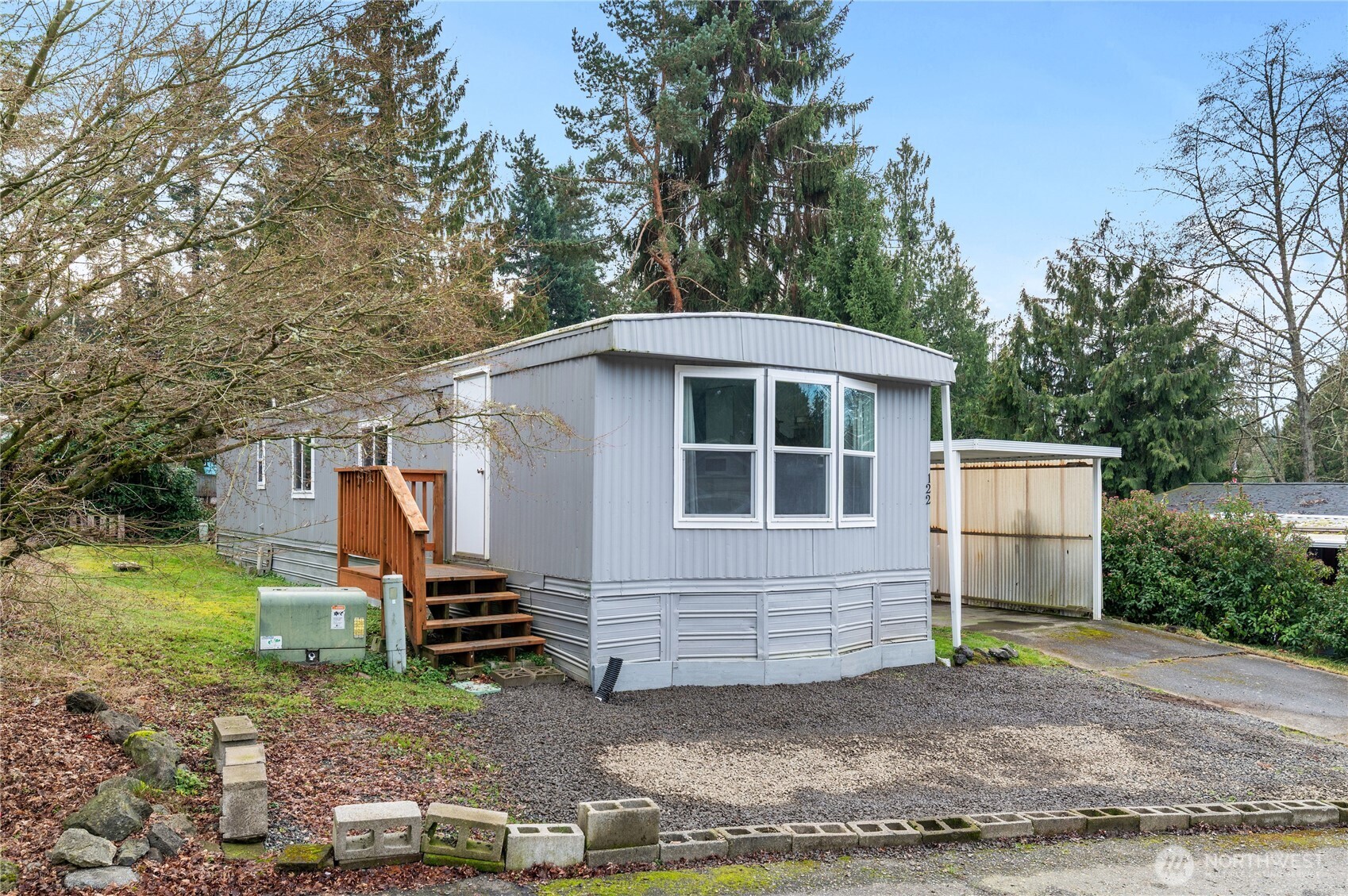 3060 Northeast McWilliams Road, Unit 122 Bremerton, WA 98311 - Photo 1 of 20 a view of a house with backyard and trees