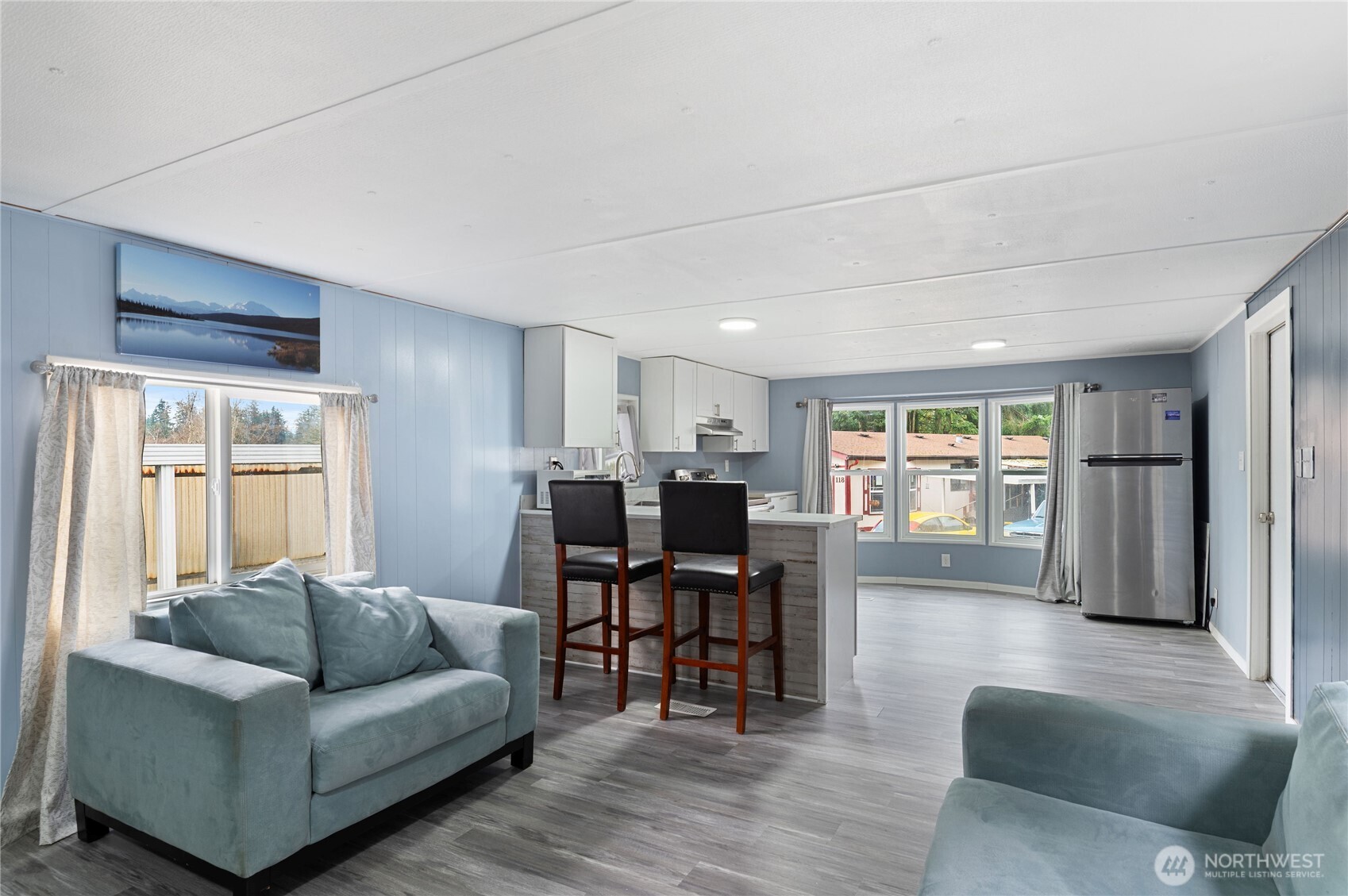 3060 Northeast McWilliams Road, Unit 122 Bremerton, WA 98311 - Photo 11 of 20 a living room with furniture and a large window