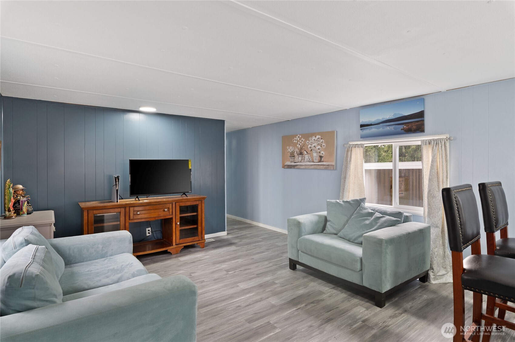 3060 Northeast McWilliams Road, Unit 122 Bremerton, WA 98311 - Photo 12 of 20 a living room with furniture and a flat screen tv