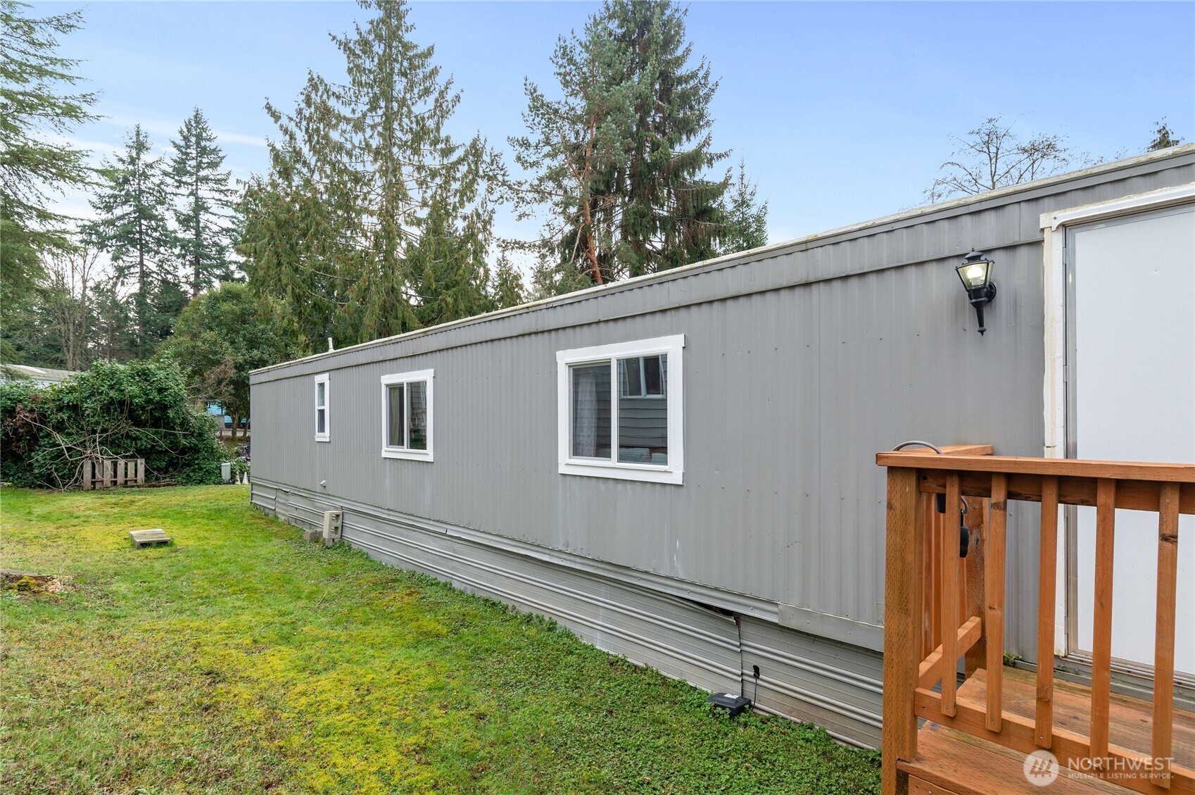 3060 Northeast McWilliams Road, Unit 122 Bremerton, WA 98311 - Photo 18 of 20 a view of a backyard with a large tree