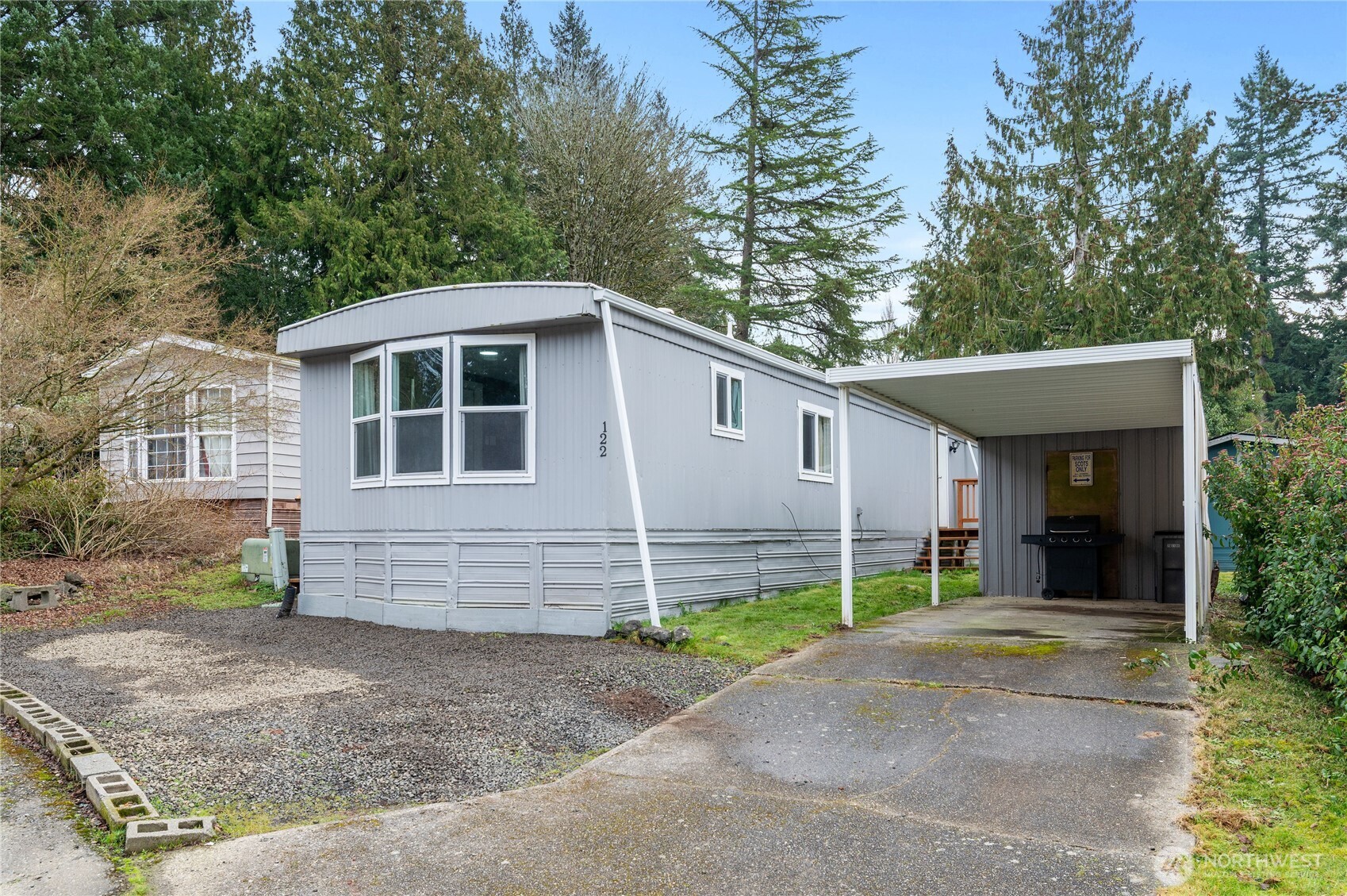 3060 Northeast McWilliams Road, Unit 122 Bremerton, WA 98311 - Photo 2 of 20 a view of a house with a yard and garage