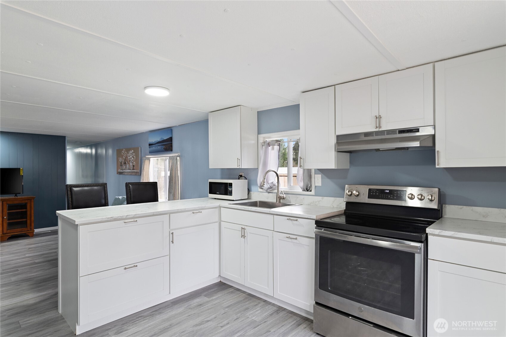 3060 Northeast McWilliams Road, Unit 122 Bremerton, WA 98311 - Photo 5 of 20 a kitchen with a sink stove and cabinets