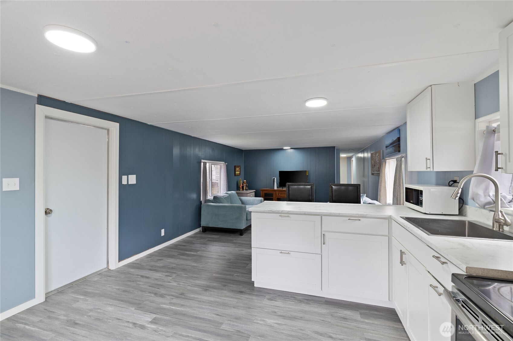 3060 Northeast McWilliams Road, Unit 122 Bremerton, WA 98311 - Photo 7 of 20 a kitchen with kitchen island a white counter top space cabinets and stainless steel appliances