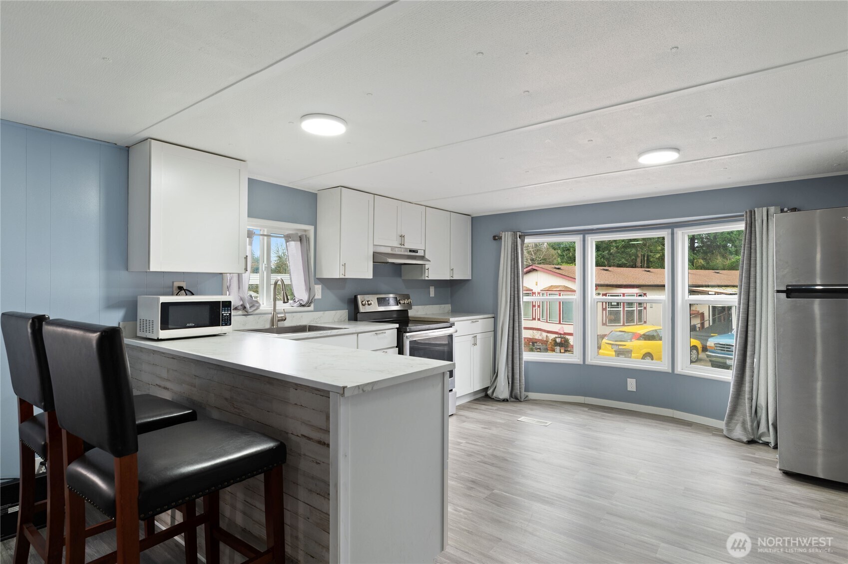 3060 Northeast McWilliams Road, Unit 122 Bremerton, WA 98311 - Photo 9 of 20 a kitchen with refrigerator and windows