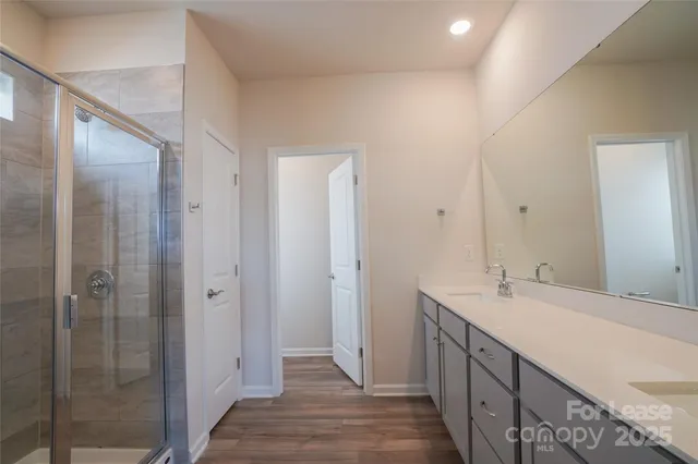 a bathroom with a double vanity sink and a mirror