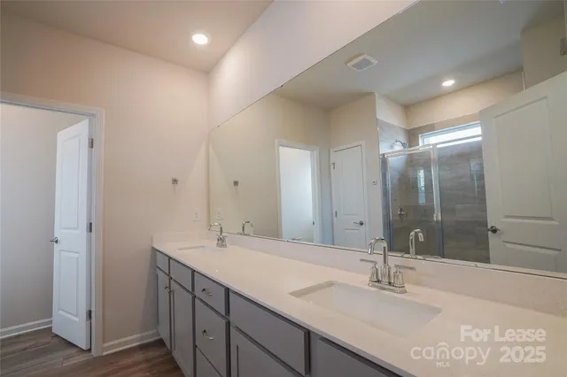 a bathroom with a glass shower door