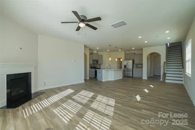 a kitchen with kitchen island a sink stainless steel appliances and refrigerator