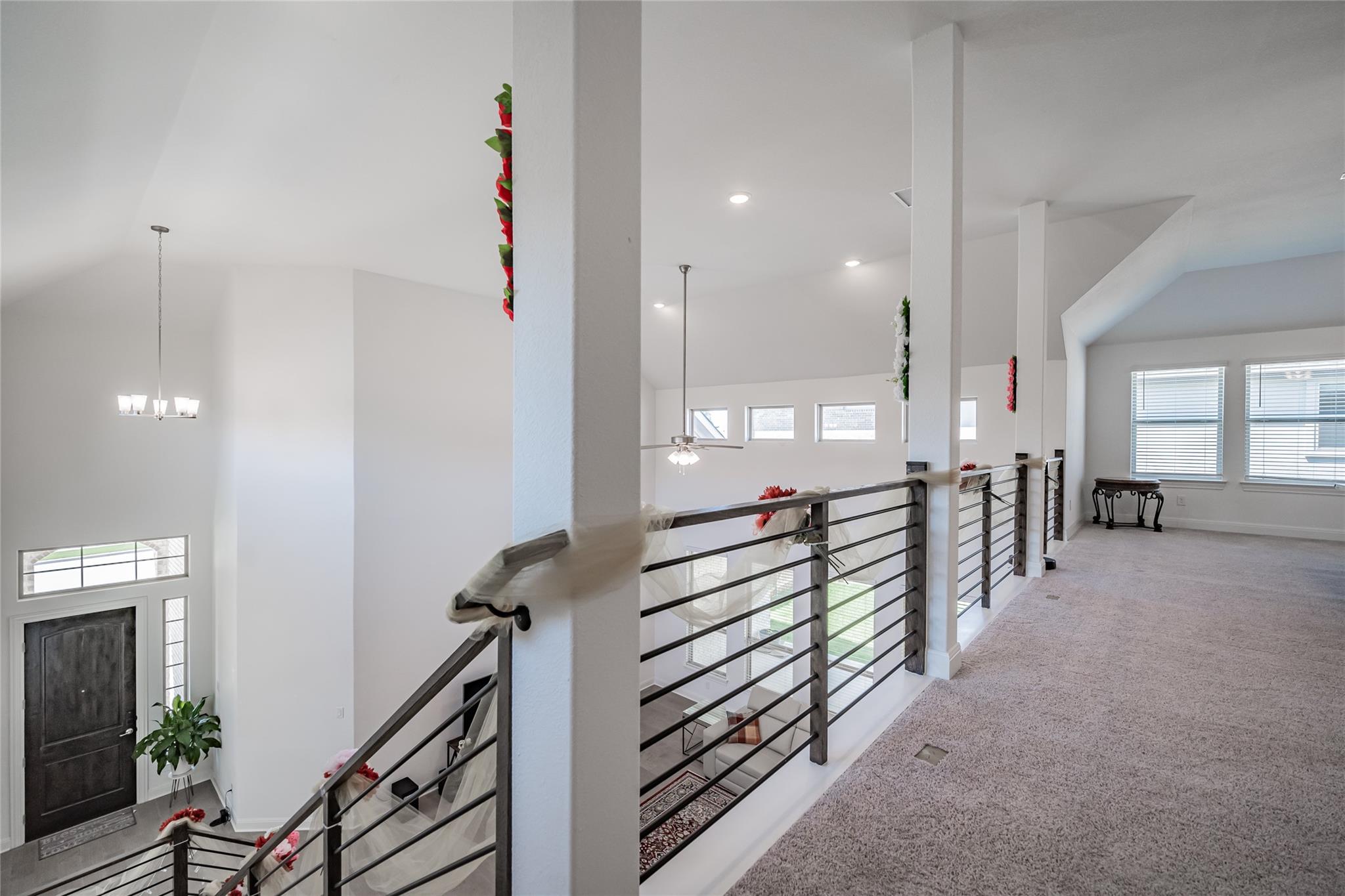 3049 Sage Ranch Drive Leander, TX 78641 - Photo 11 of 23 A spacious landing connects bedrooms, offering an elegant view of the grand entryway below.