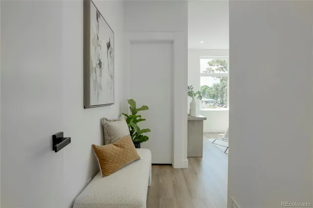 a hallway with front door and wooden floor