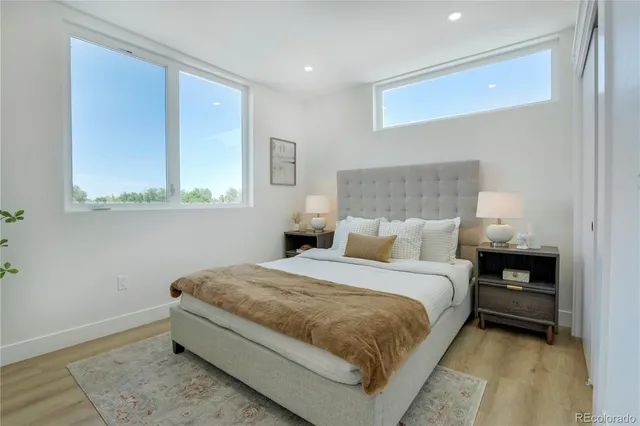 a bed room with a bed and a night stand