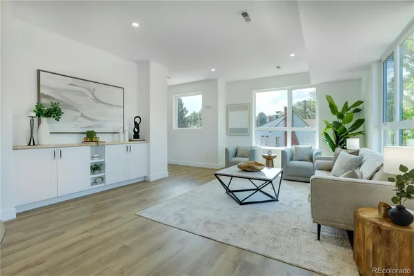 a living room with furniture and large windows