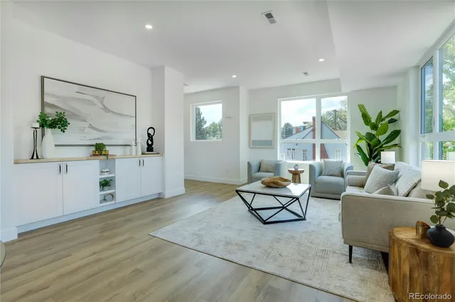 a living room with furniture and large windows