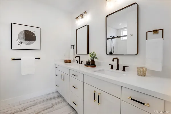 a bathroom with a double vanity sink and mirror