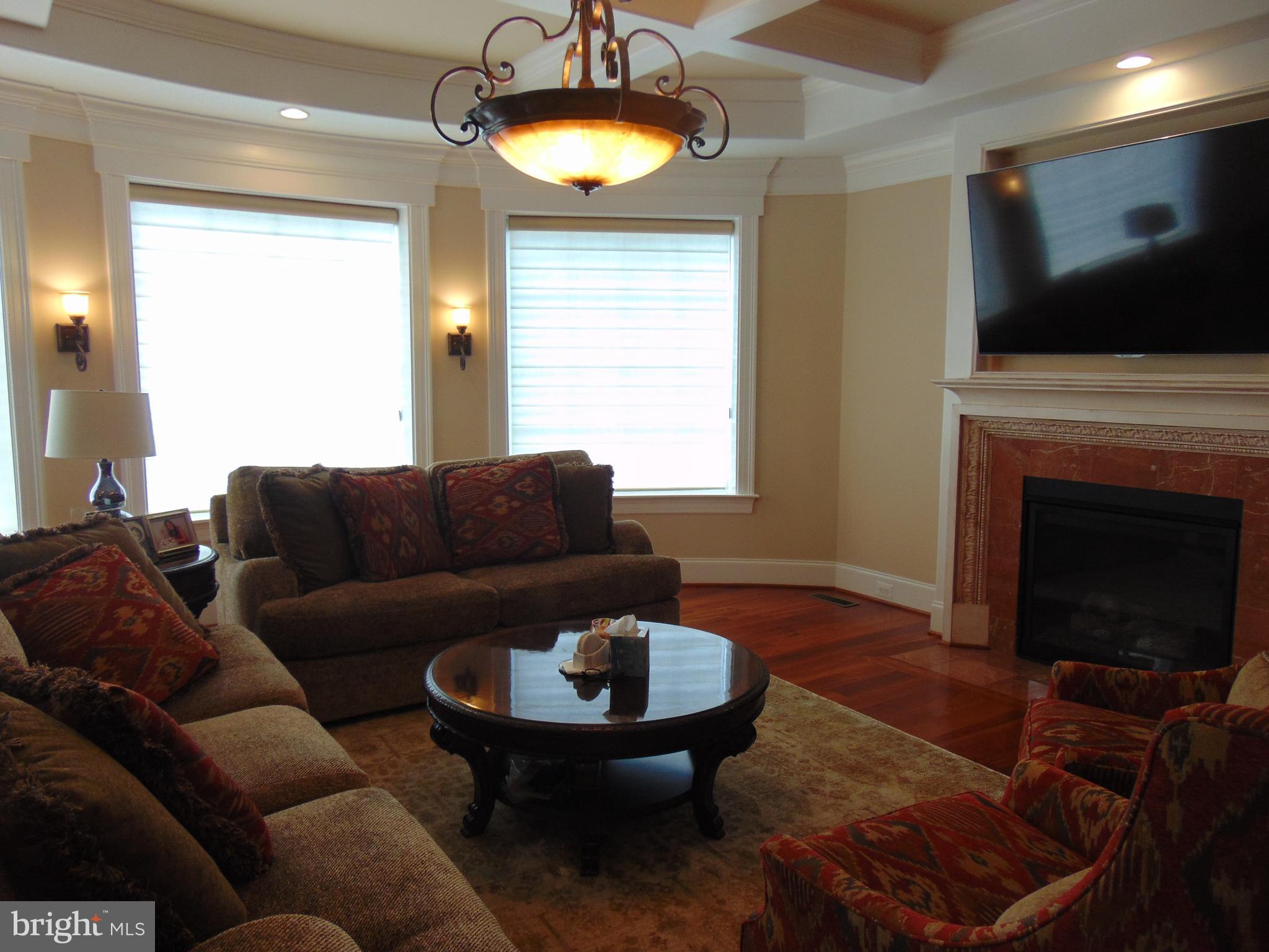 1027 Towlston Road McLean, VA 22102 - Photo 21 of 59 a living room with furniture a fireplace and a flat screen tv