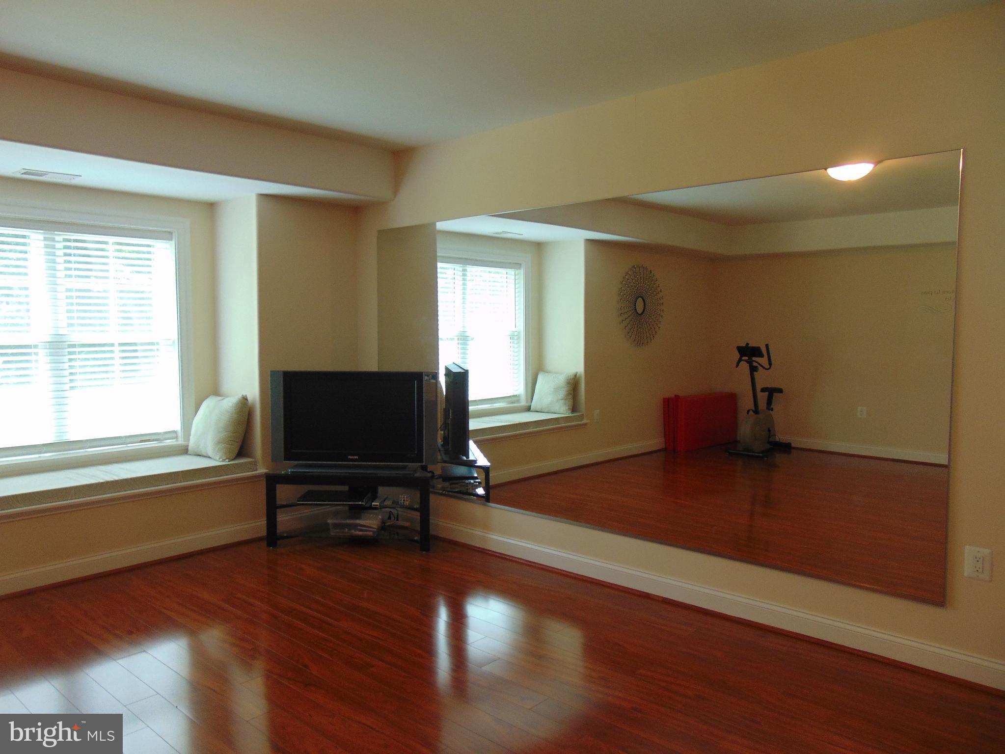 1027 Towlston Road McLean, VA 22102 - Photo 29 of 59 a view of a livingroom with wooden floor and a flat screen tv