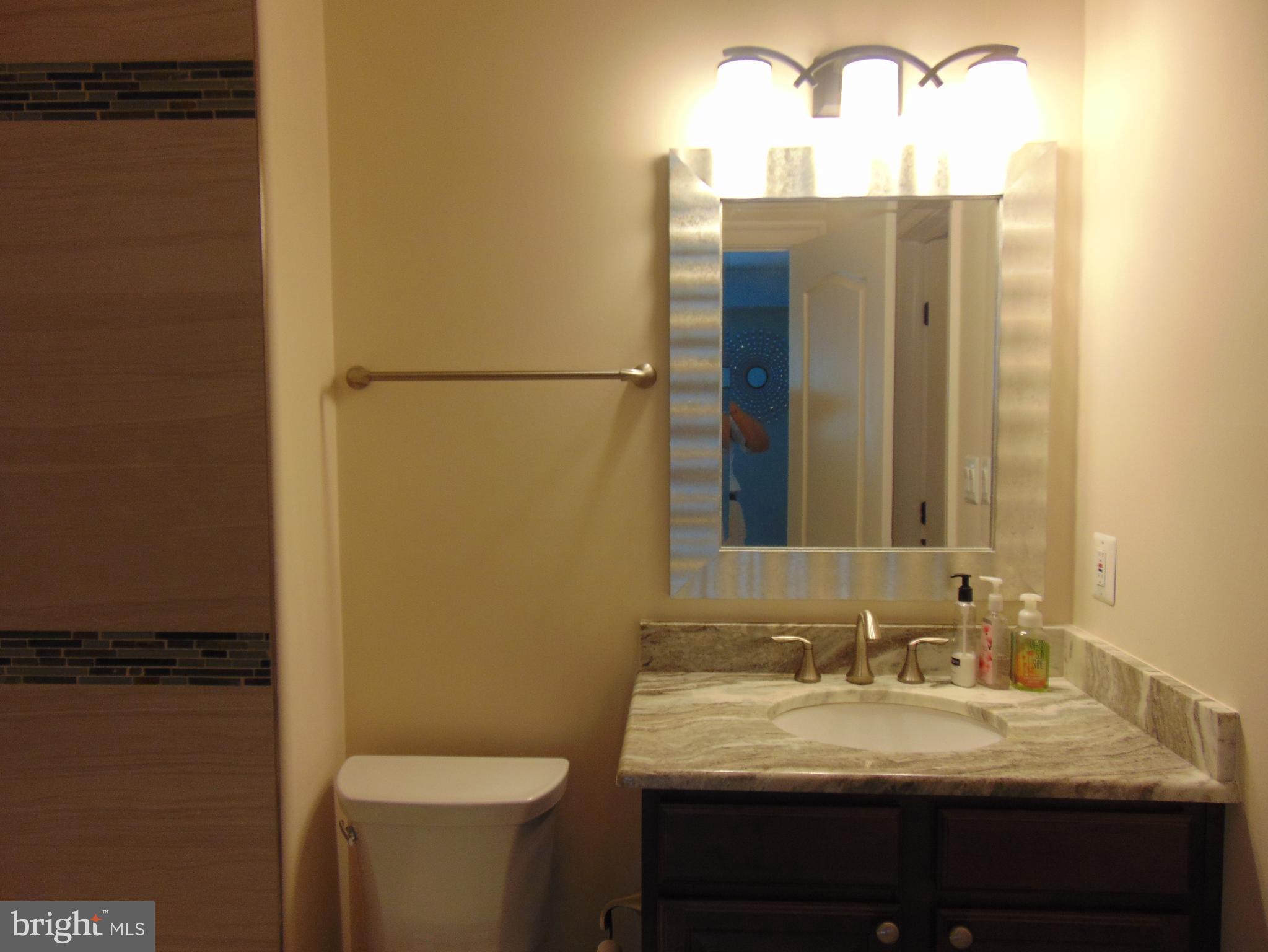 1027 Towlston Road McLean, VA 22102 - Photo 30 of 59 a bathroom with a granite countertop sink and a mirror