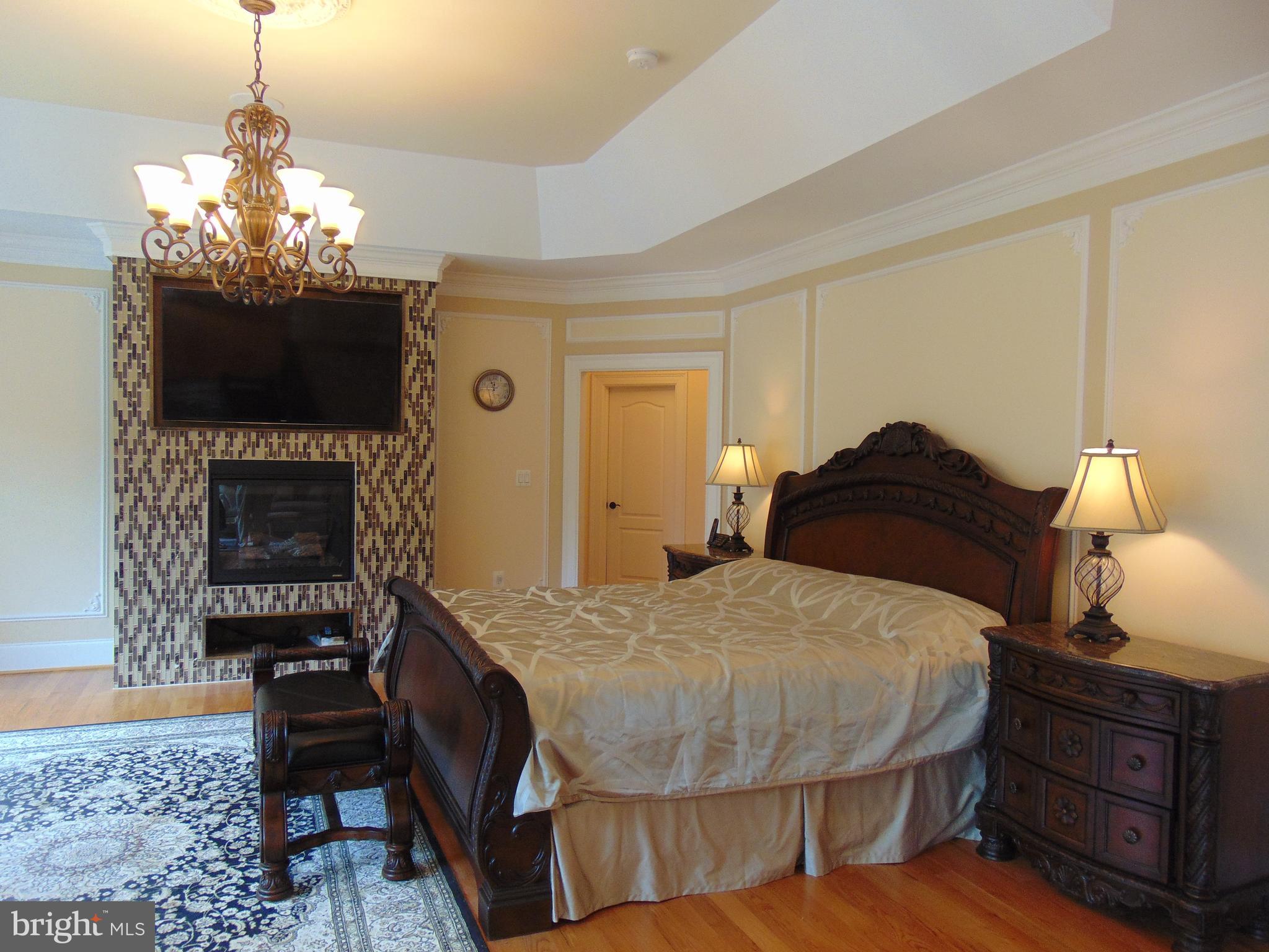 1027 Towlston Road McLean, VA 22102 - Photo 41 of 59 a bedroom with a bed and a chandelier