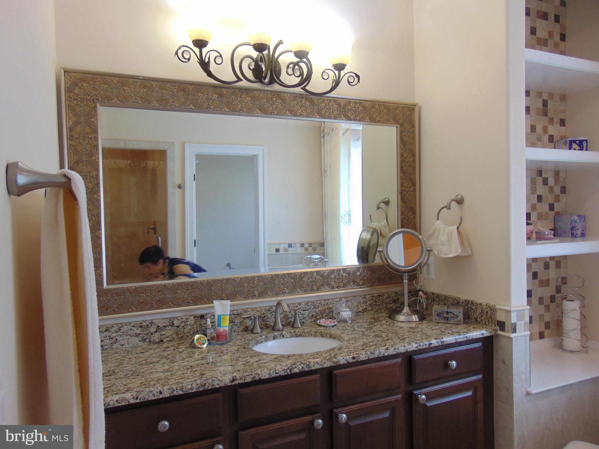 1027 Towlston Road McLean, VA 22102 - Photo 48 of 59 a bathroom with a granite countertop sink and a mirror
