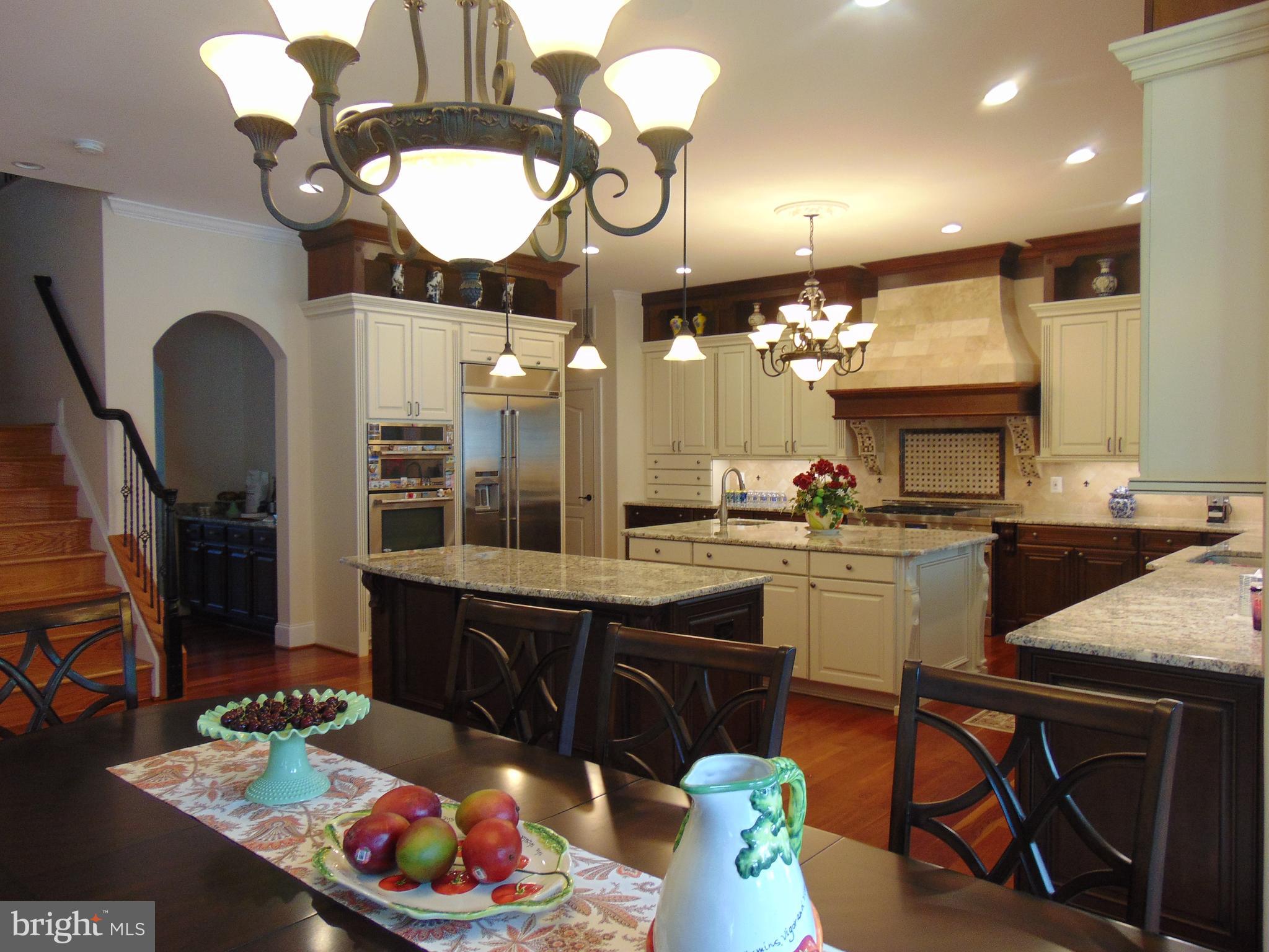 1027 Towlston Road McLean, VA 22102 - Photo 8 of 59 a kitchen with a sink dishwasher and a dining table with kitchen view