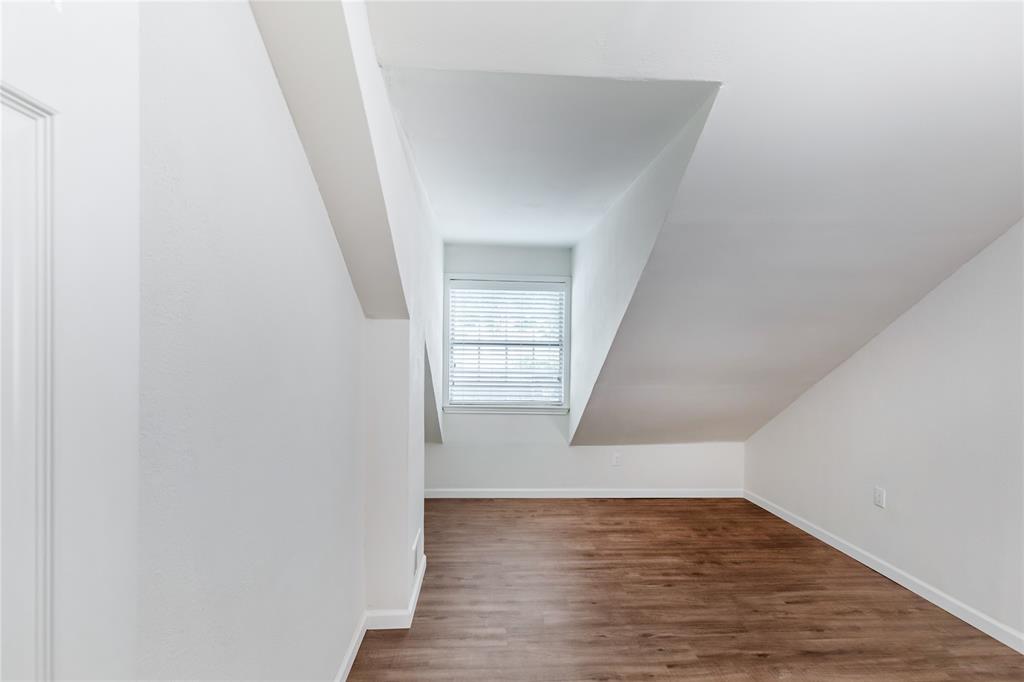 12680 Hillcrest Road, Unit 4101 Dallas, TX 75230 - Photo 32 of 37 Room with sloped ceilings, wood-finish flooring, and a window with blinds
