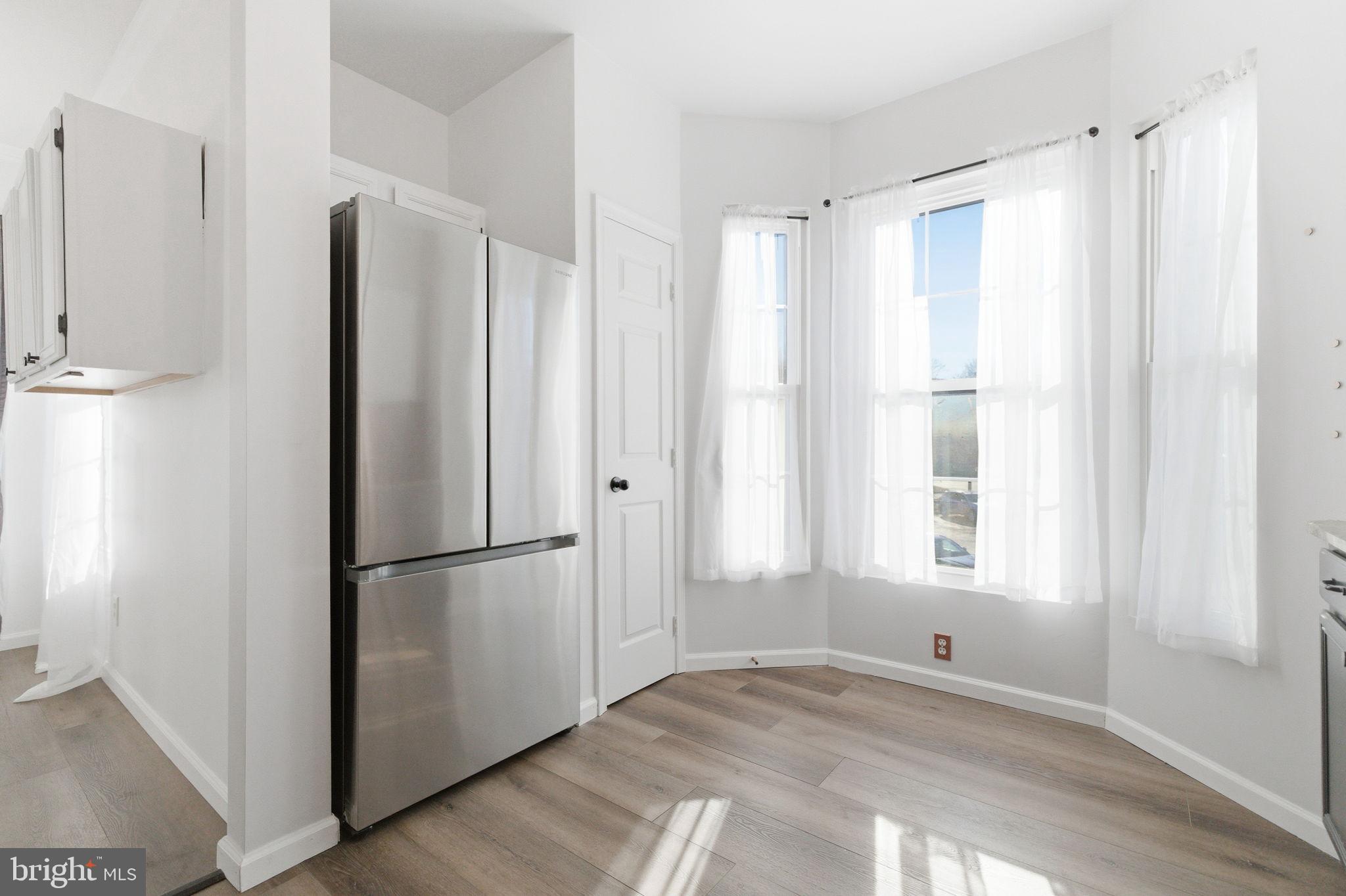 20419 Riverbend Square, Unit 200 Sterling, VA 20165 - Photo 12 of 39 a view of a kitchen with wooden floor and a window