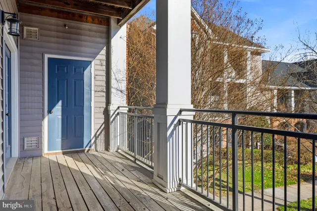 a view of balcony with wooden floor and fence