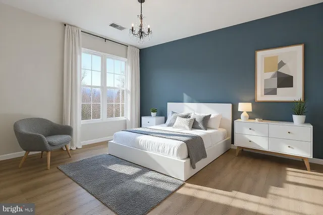 a spacious bedroom with a bed and window