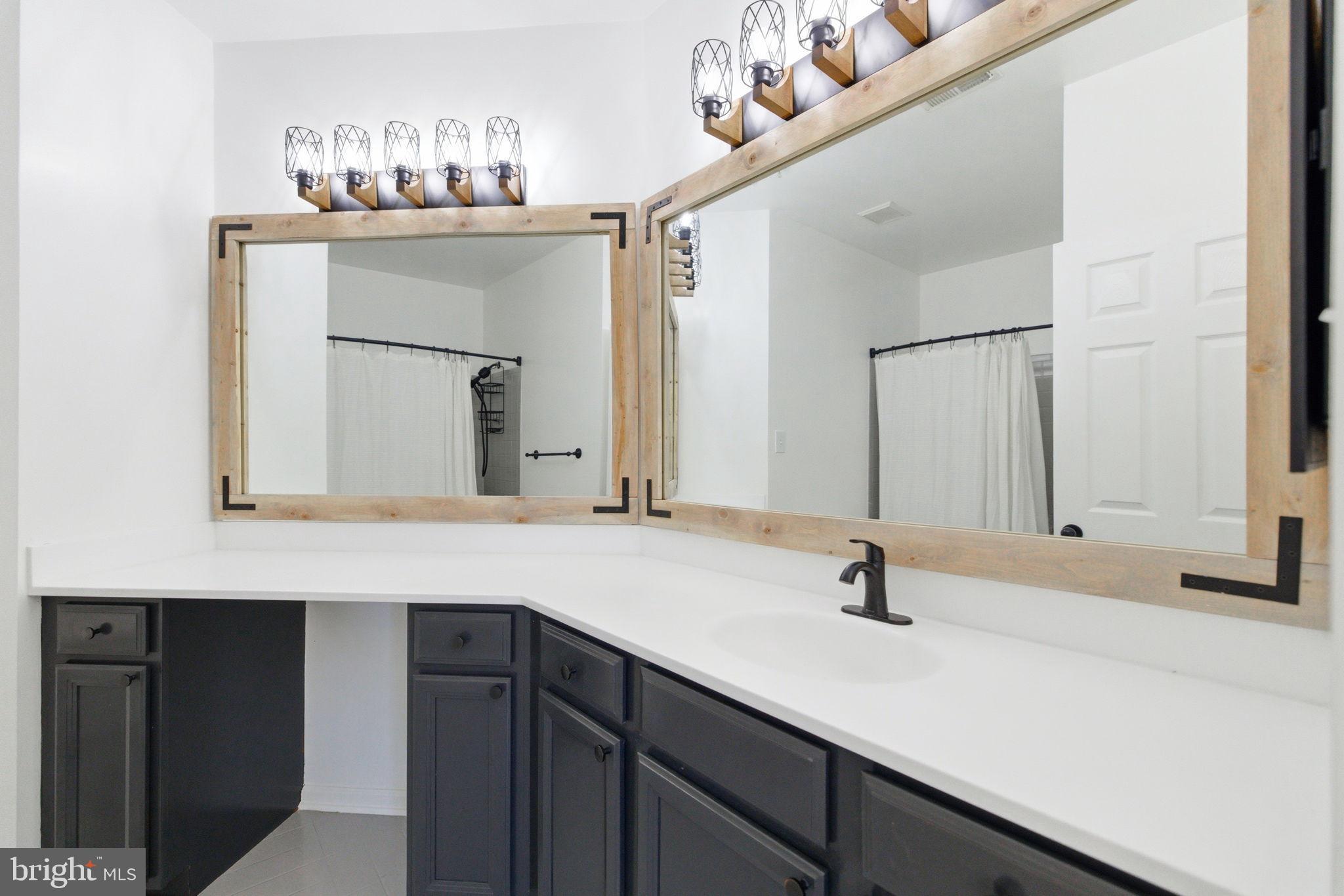 20419 Riverbend Square, Unit 200 Sterling, VA 20165 - Photo 20 of 39 a bathroom with a sink and a mirror